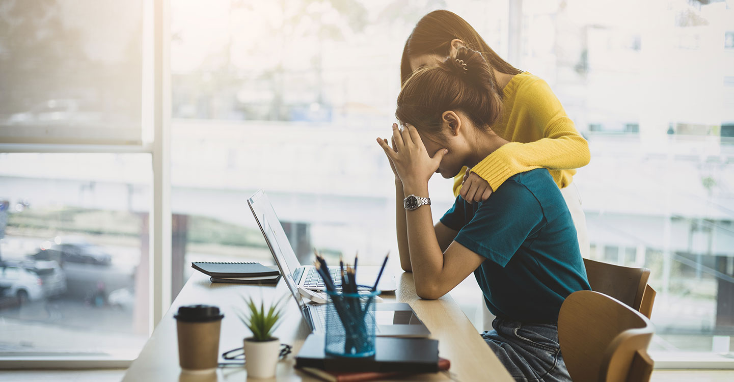 Une employée réconforte sa collègue au travail